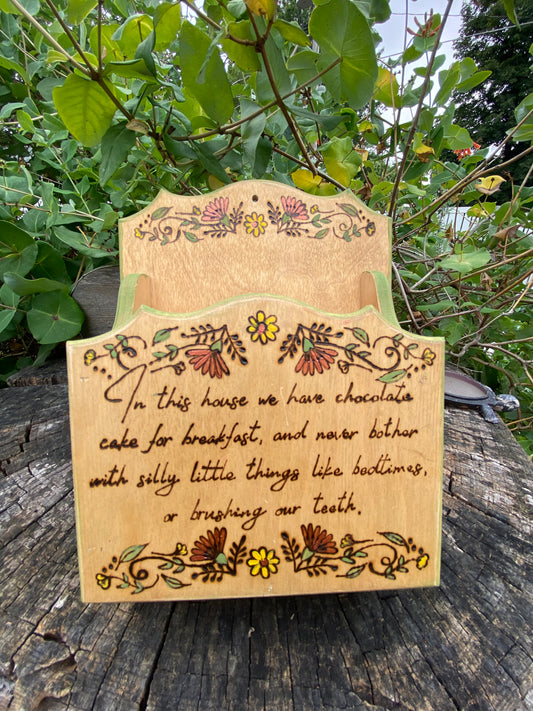 “In this house” wall container